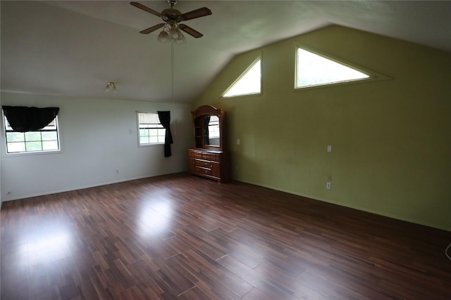 bonus room with ceiling fan, vaulted ceiling, dark wood-style flooring, and baseboards