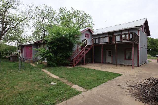 back of property with a patio area, stairway, a yard, and a deck
