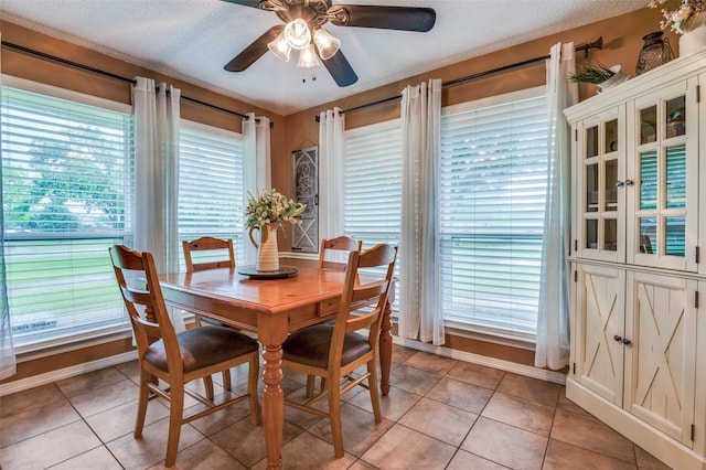 3451 Sudith Ln, Midlothian, TX 76065 - dining space featuring ceiling fan, baseboards, light tile patterned floors, and a textured ceiling
