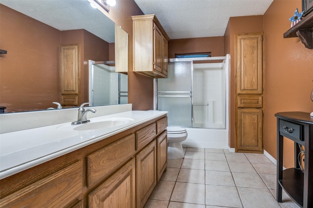 3451 Sudith Ln, Midlothian, TX 76065 - full bath with a textured ceiling, toilet, vanity, tile patterned floors, and shower / bath combination with glass door