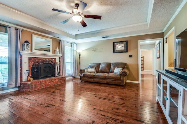 3451 Sudith Ln, Midlothian, TX 76065 - living area with crown molding, a textured ceiling, hardwood / wood-style flooring, a ceiling fan, and a brick fireplace
