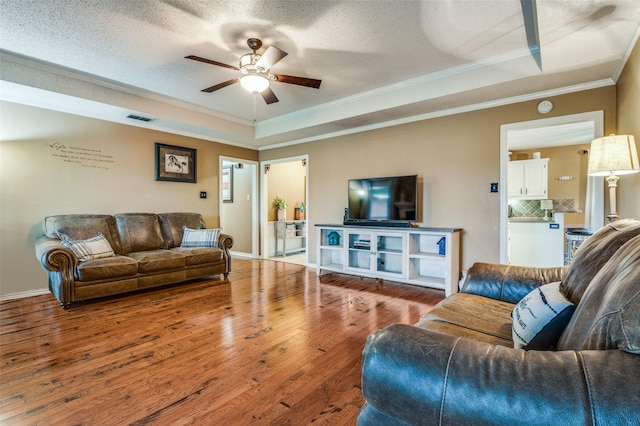 3451 Sudith Ln, Midlothian, TX 76065 - living area featuring crown molding, a ceiling fan, a tray ceiling, hardwood / wood-style floors, and baseboards