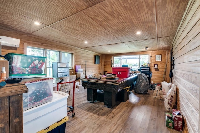 playroom with wooden ceiling, wood walls, a wall unit AC, and wood finished floors