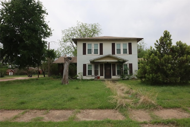 view of front of property with a sunroom and a front yard