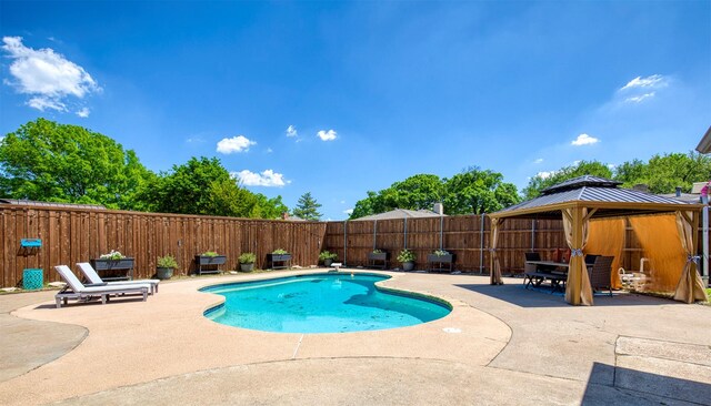 view of swimming pool featuring a gazebo, a patio area, a fenced in pool, and a fenced backyard