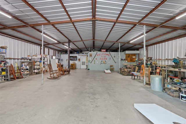 garage with a workshop area and metal wall