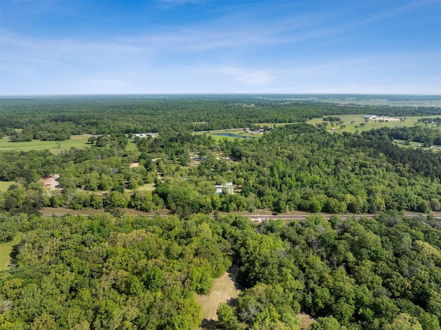 bird's eye view featuring a wooded view