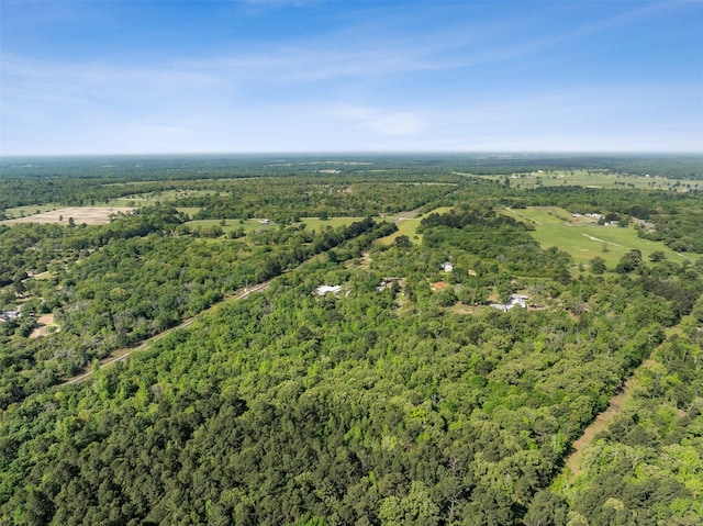 birds eye view of property with a view of trees