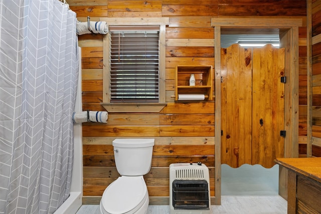 bathroom with a shower with shower curtain, wooden walls, toilet, and heating unit