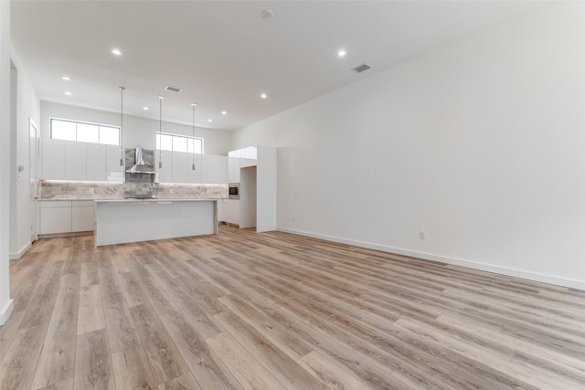 1775 Novela Way, Dallas, TX 75215 - unfurnished living room with light wood-style flooring, recessed lighting, and baseboards