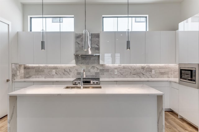1775 Novela Way, Dallas, TX 75215 - kitchen with wall chimney range hood, stainless steel microwave, modern cabinets, and decorative backsplash