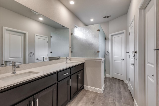 736 Wilmott Ter, Fort Worth, TX 76247 - full bathroom featuring wood finished floors, double vanity, a stall shower, baseboards, and recessed lighting