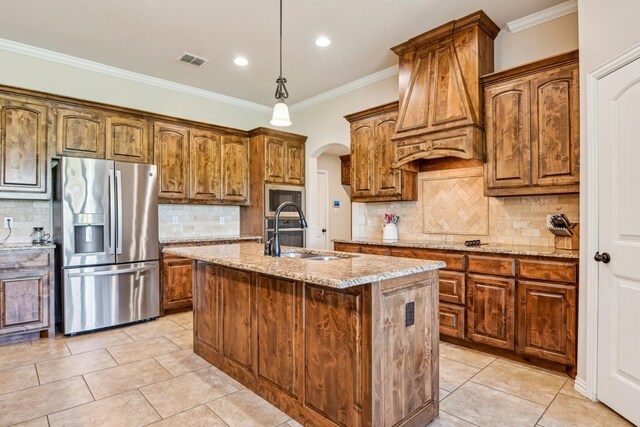 kitchen with stainless steel appliances, a sink, visible vents, light stone counters, and ornamental molding