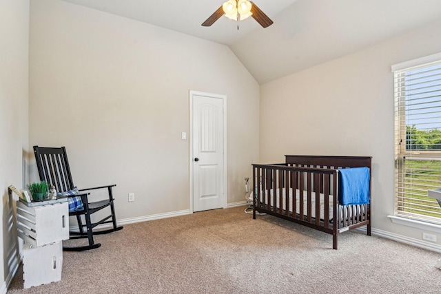 bedroom with a nursery area, carpet floors, lofted ceiling, and baseboards
