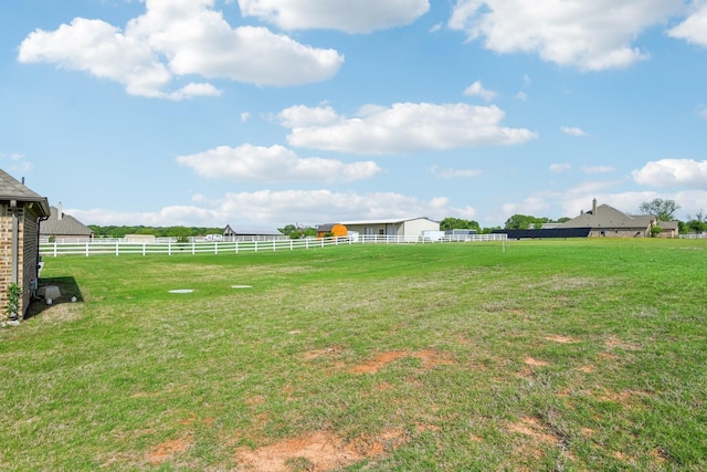 view of yard with a rural view and fence