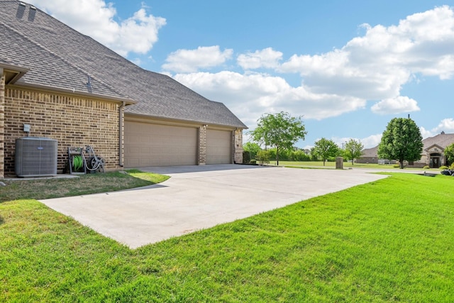 exterior space featuring a garage, driveway, and central AC