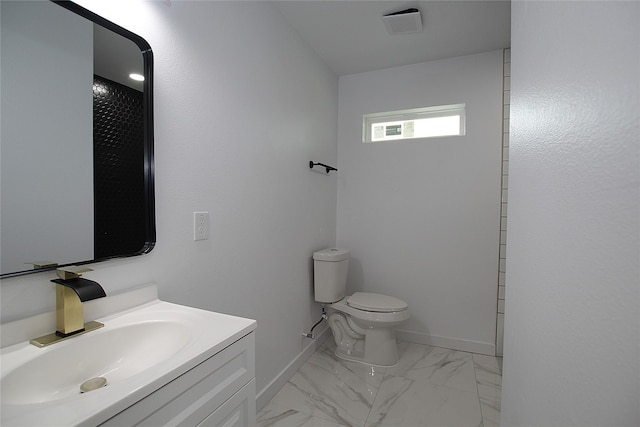 2427 Costa Mesa Dr, Dallas, TX 75228 - bathroom with baseboards, vanity, marble finish floor, and toilet