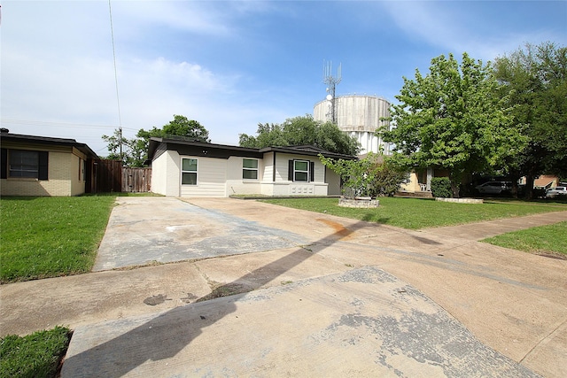 2427 Costa Mesa Dr, Dallas, TX 75228 - view of front facade featuring fence, a front lawn, and concrete driveway
