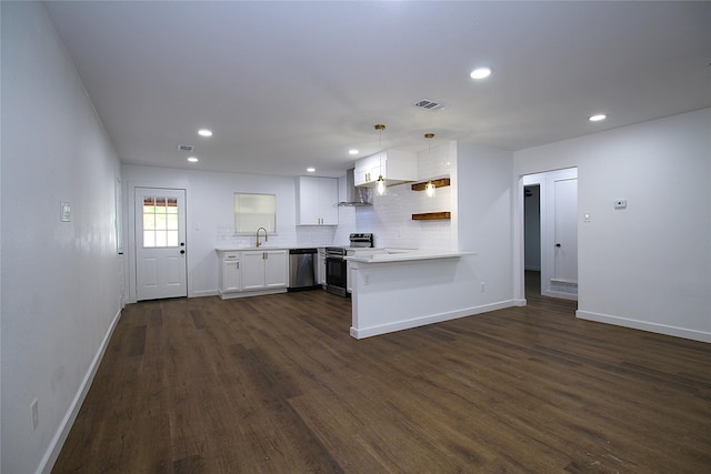 2427 Costa Mesa Dr, Dallas, TX 75228 - kitchen featuring dark wood-style floors, light countertops, baseboards, a peninsula, and appliances with stainless steel finishes