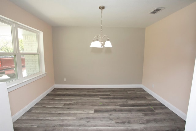 interior space with a chandelier, baseboards, visible vents, and dark wood-style floors