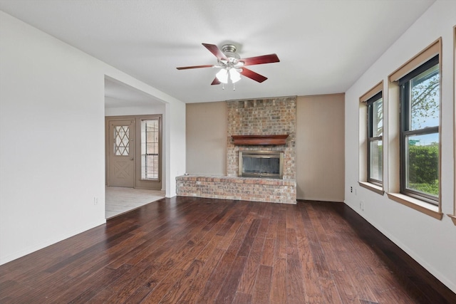 112 Bow Creek Cir, Red Oak, TX 75154 - unfurnished living room with wood finished floors, a ceiling fan, plenty of natural light, and a brick fireplace