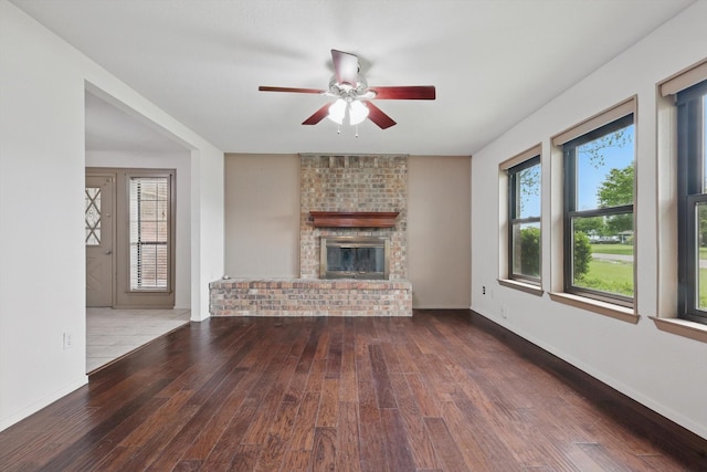 unfurnished living room featuring wood-type flooring, a ceiling fan, and a fireplace