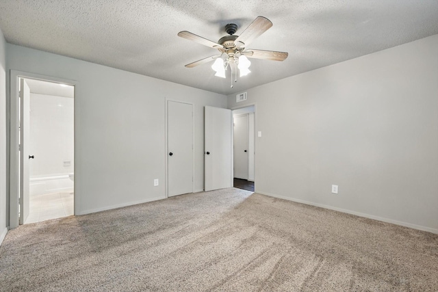 112 Bow Creek Cir, Red Oak, TX 75154 - unfurnished bedroom with carpet, connected bathroom, a textured ceiling, baseboards, and a ceiling fan