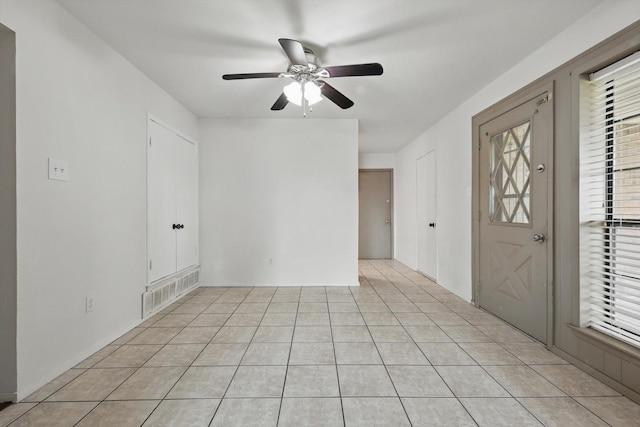 foyer with ceiling fan, visible vents, and light tile patterned floors