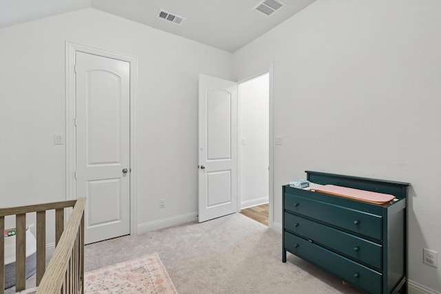 unfurnished bedroom with light carpet, visible vents, and baseboards