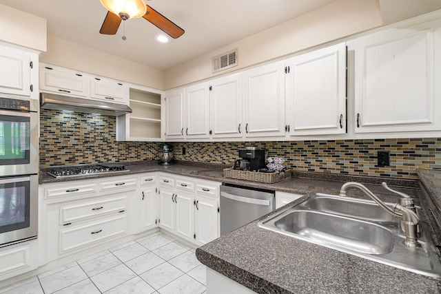 kitchen featuring visible vents, dark countertops, under cabinet range hood, and appliances with stainless steel finishes