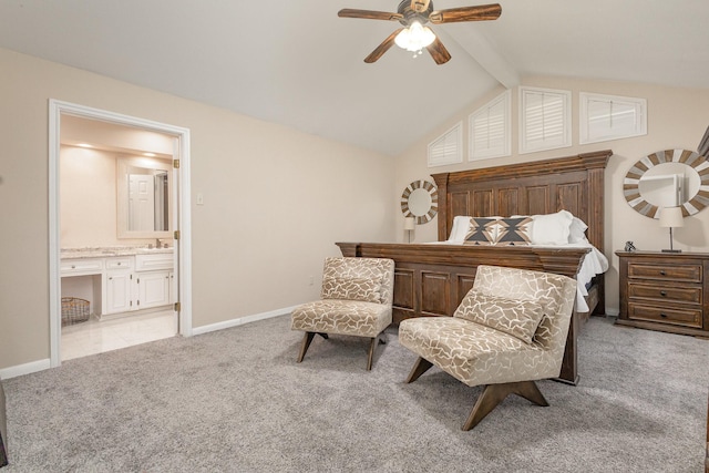 bedroom with a sink, lofted ceiling with beams, light carpet, baseboards, and ensuite bath