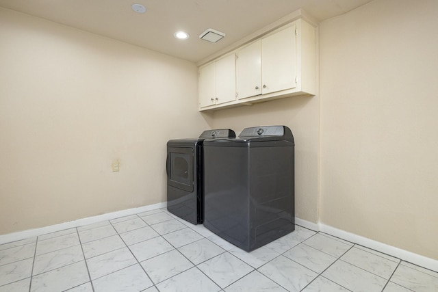 laundry area featuring baseboards, independent washer and dryer, recessed lighting, and cabinet space