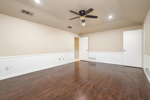 spare room with wood finished floors, visible vents, and ceiling fan