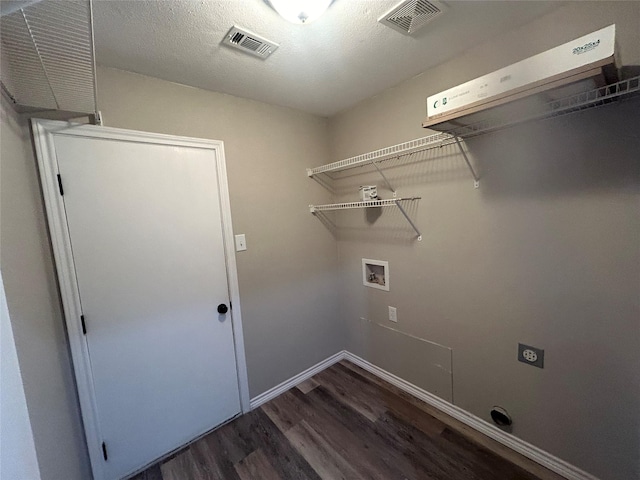 laundry room with laundry area, wood finished floors, visible vents, and washer hookup