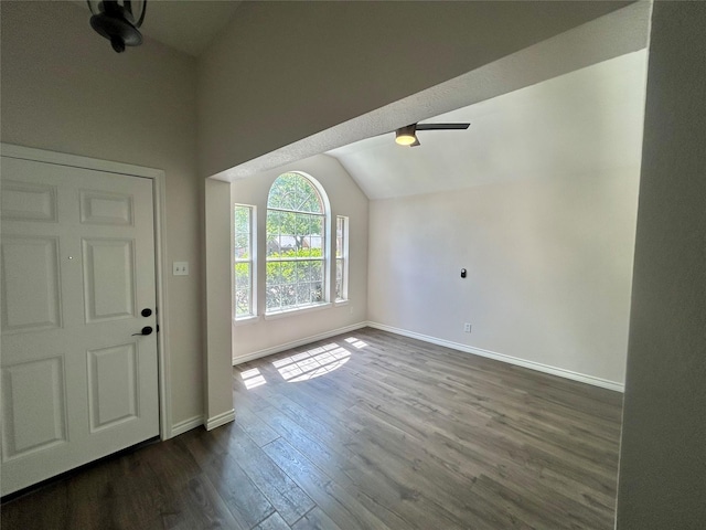 foyer featuring dark wood-type flooring, lofted ceiling, baseboards, and ceiling fan