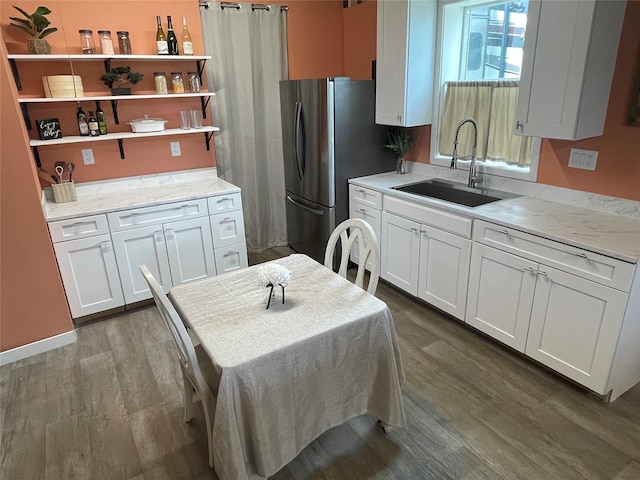 kitchen with white cabinetry, a sink, and dark wood-type flooring