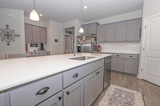 4125 Stockman Dr, Krum, TX 76249 - kitchen with gray cabinetry, a sink, appliances with stainless steel finishes, backsplash, and recessed lighting
