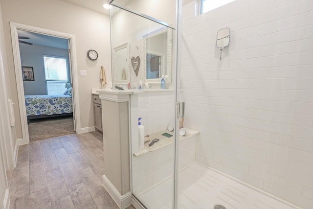 4125 Stockman Dr, Krum, TX 76249 - full bathroom with vanity, connected bathroom, a shower stall, wood finished floors, and baseboards