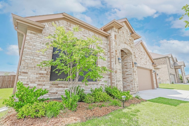 4125 Stockman Dr, Krum, TX 76249 - view of front facade with concrete driveway, stone siding, an attached garage, and a front yard