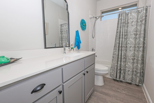 4125 Stockman Dr, Krum, TX 76249 - bathroom with vanity, toilet, wood finished floors, and shower / bath combo with shower curtain
