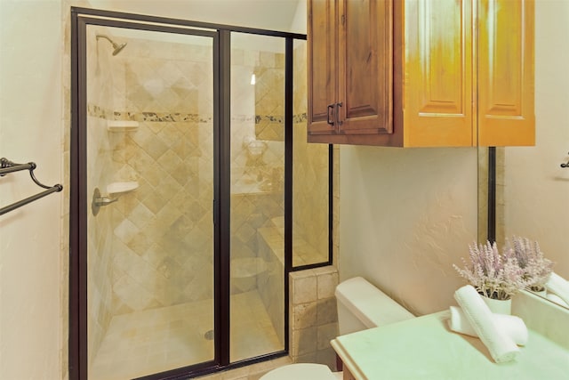 full bath with vanity, toilet, and a shower stall