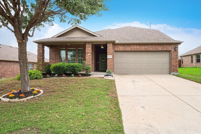 single story home with a shingled roof, an attached garage, a front lawn, brick siding, and driveway