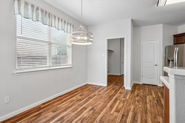 5208 Hidden Knolls Dr, Mckinney, TX 75071 - unfurnished dining area featuring a chandelier, wood finished floors, and baseboards