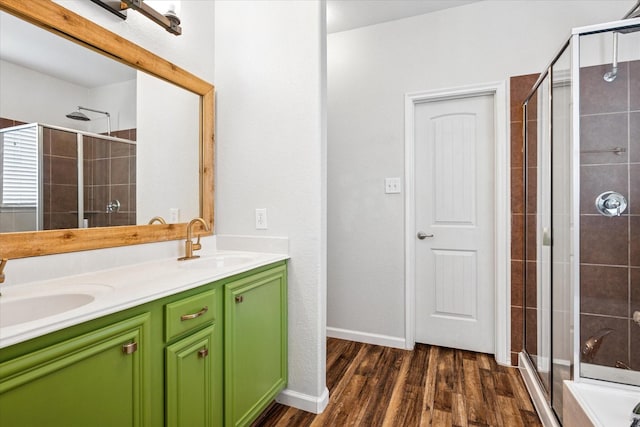 5208 Hidden Knolls Dr, Mckinney, TX 75071 - bathroom featuring a stall shower, wood finished floors, double vanity, and baseboards