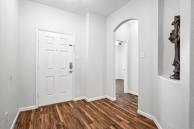 5208 Hidden Knolls Dr, Mckinney, TX 75071 - foyer with arched walkways, dark wood-style floors, and baseboards