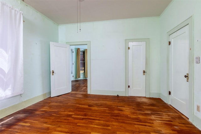 unfurnished room featuring wood finished floors and ornamental molding