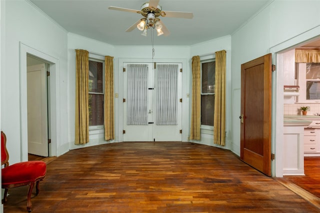 interior space featuring a ceiling fan, french doors, hardwood / wood-style flooring, and crown molding