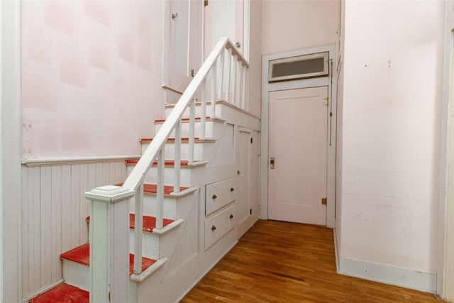 stairs featuring wood finished floors