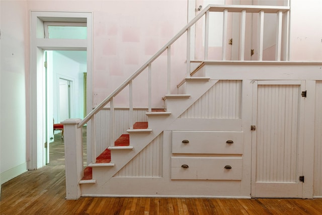 staircase with hardwood / wood-style floors