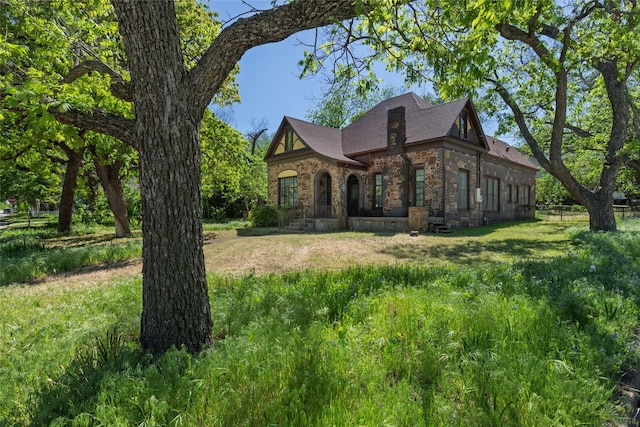 view of home's exterior featuring brick siding and stone siding